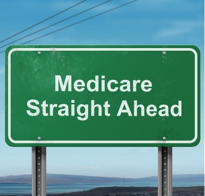 Green road sign that says Medicare Straight Ahead.
