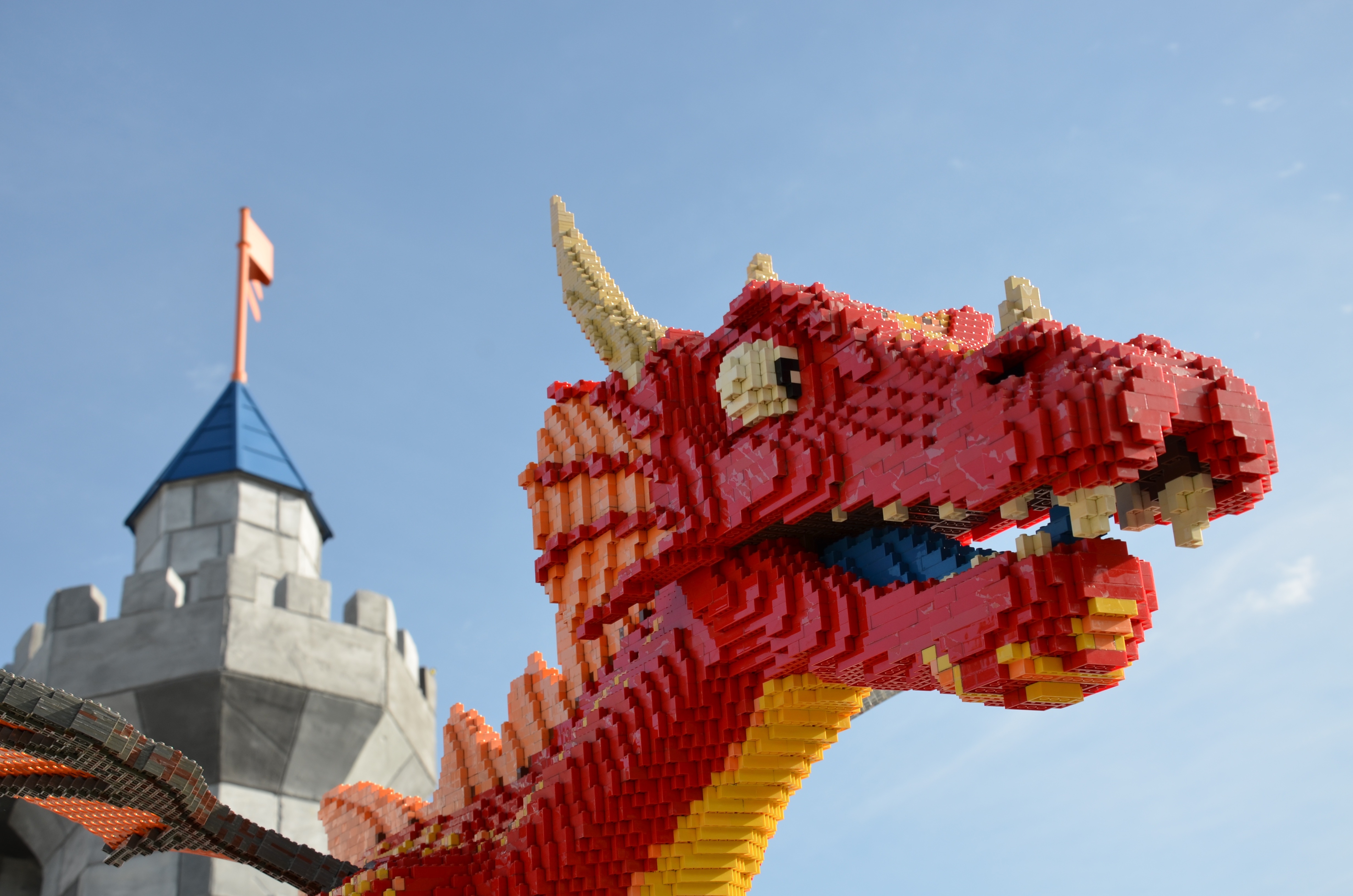 Head of a red dragon made out of legos.