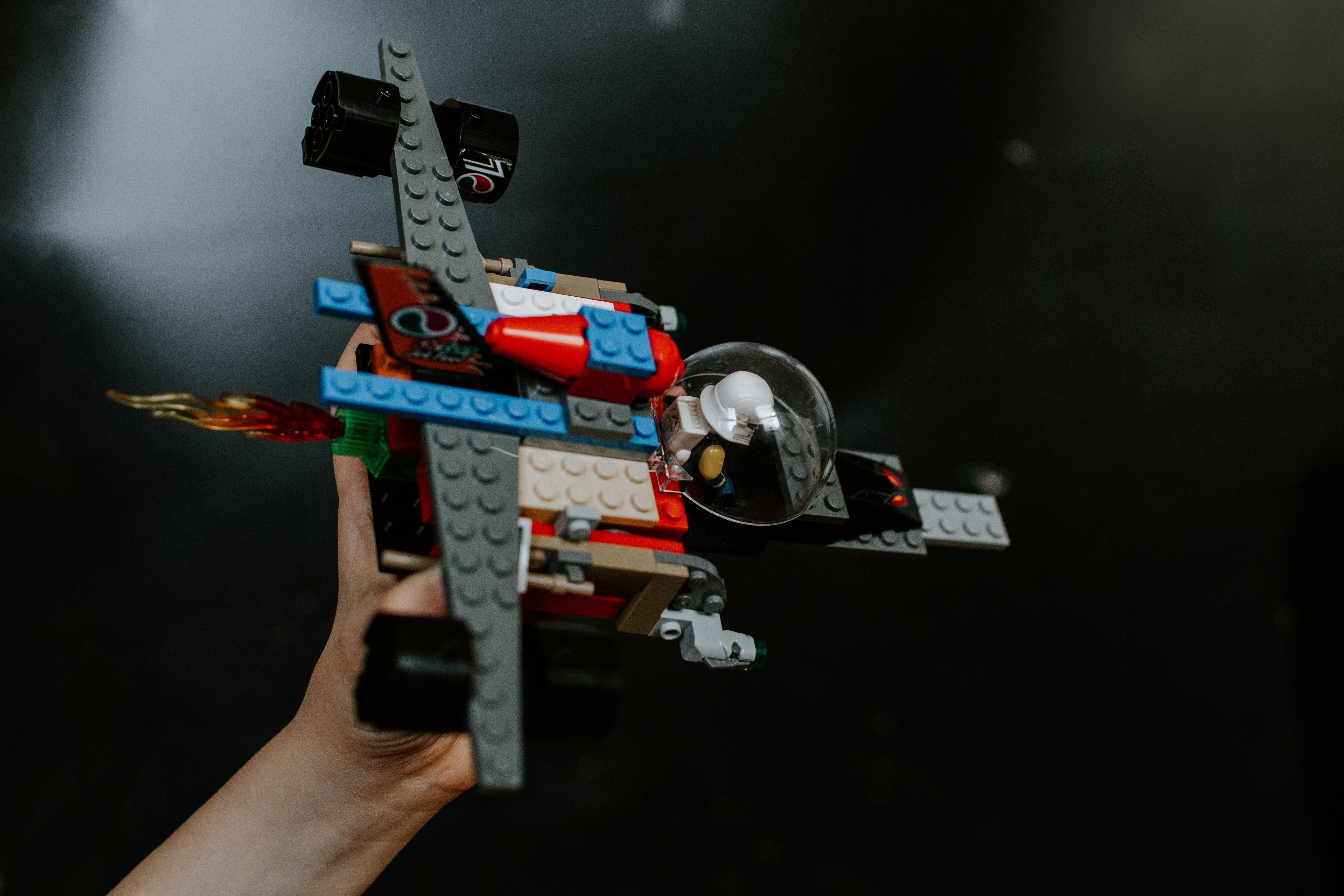 Photo of a hand holding a Lego Spaceship.