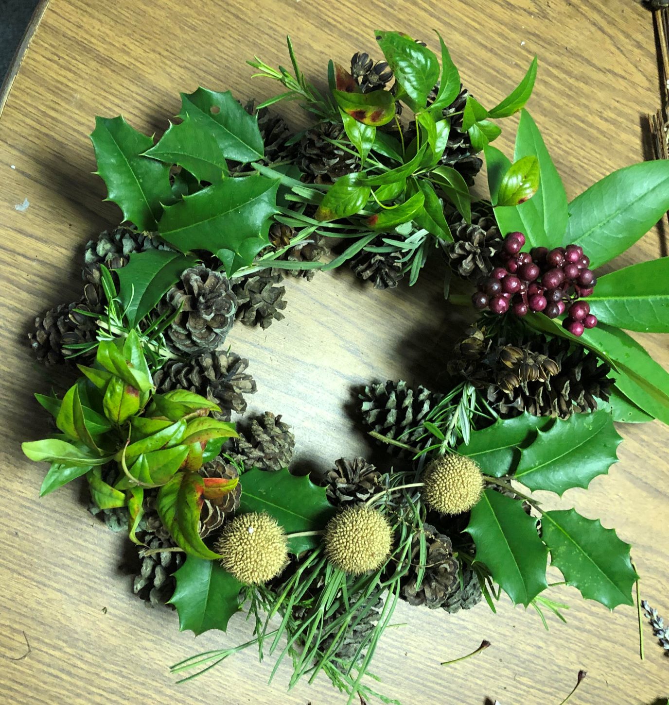 Wreath made of pine cones and greenery.