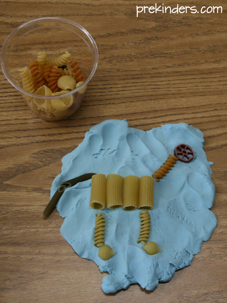 Pasta and playdough imitating dinosaur fossil.