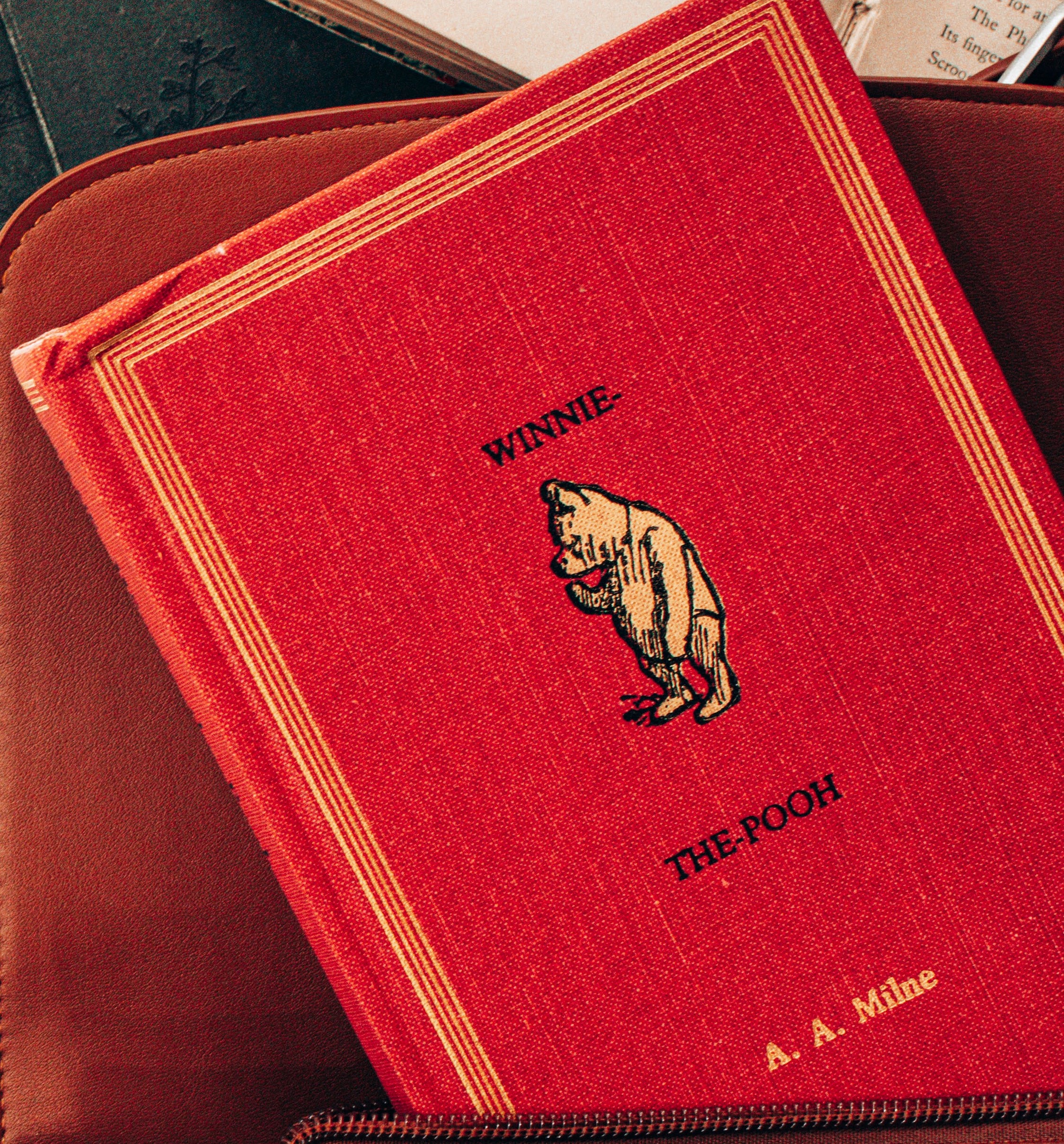 Copy of Winnie the Pooh book inside a leather bag.