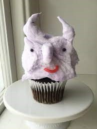 Cotton candy monster on top of a cupcake.