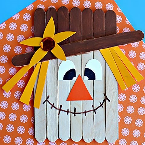 Scarecrow face made of popsicle sticks.