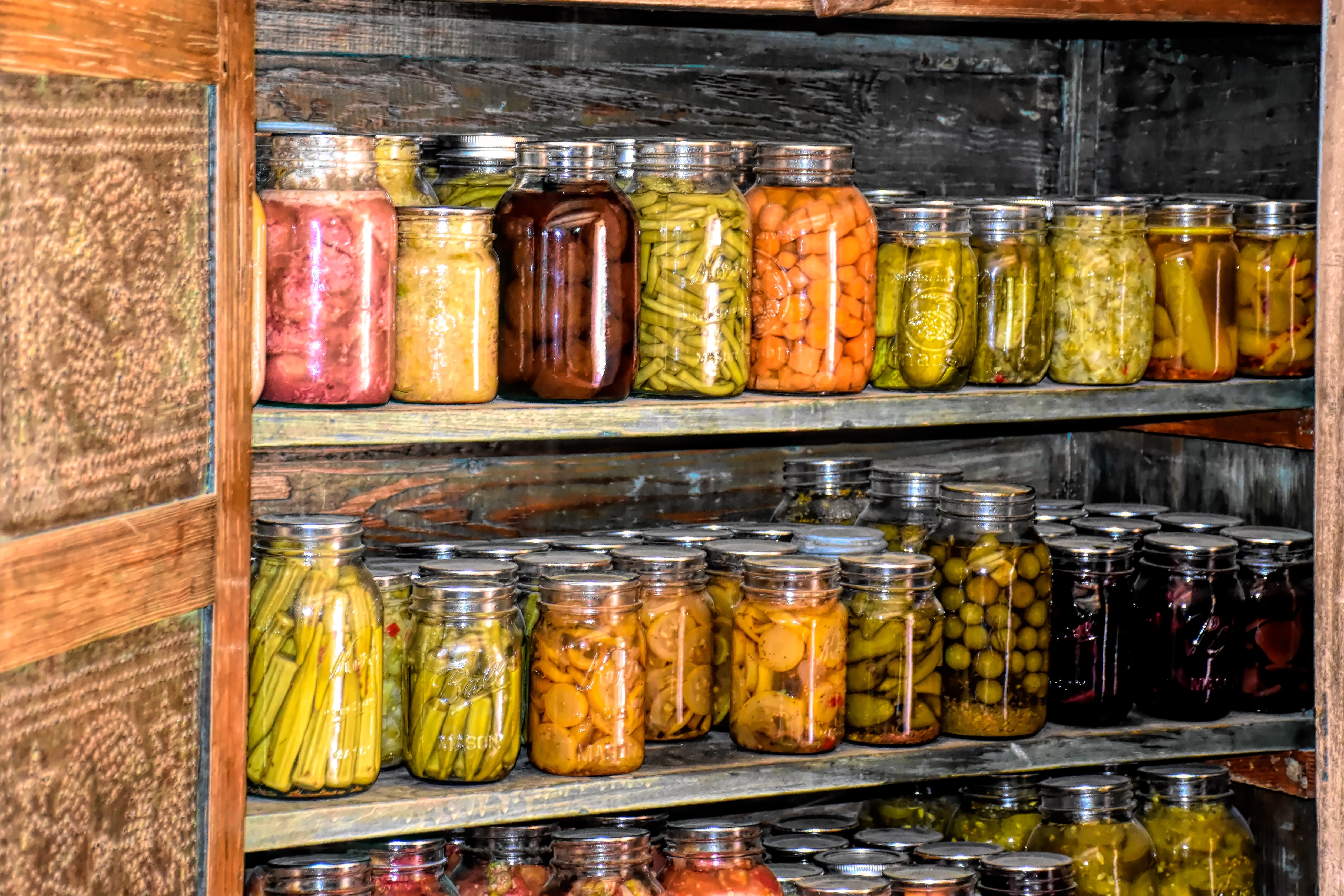 Canned vegetables on pantry shelves.