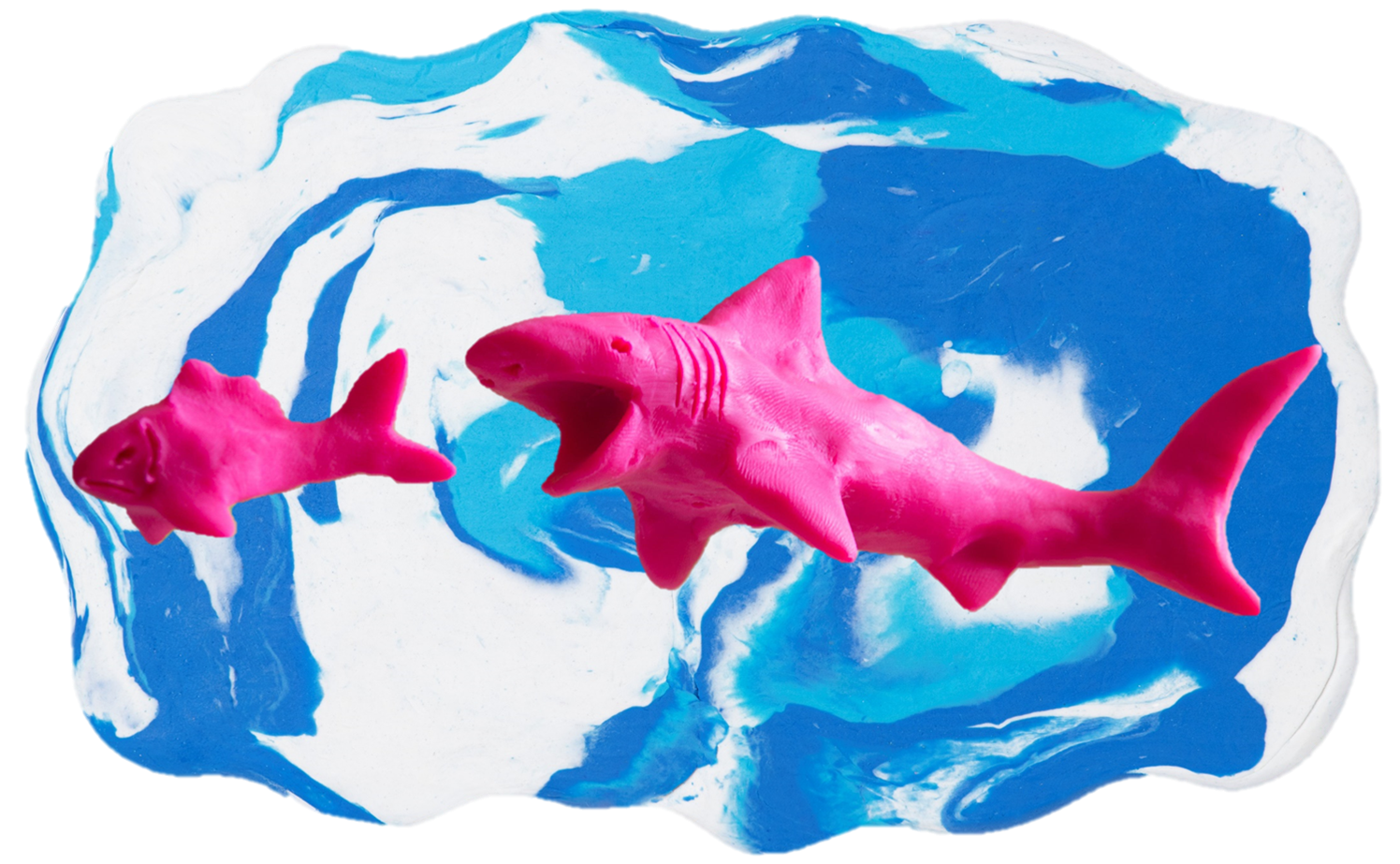 Pink shark and fish made out of clay on a blue and white clay background.