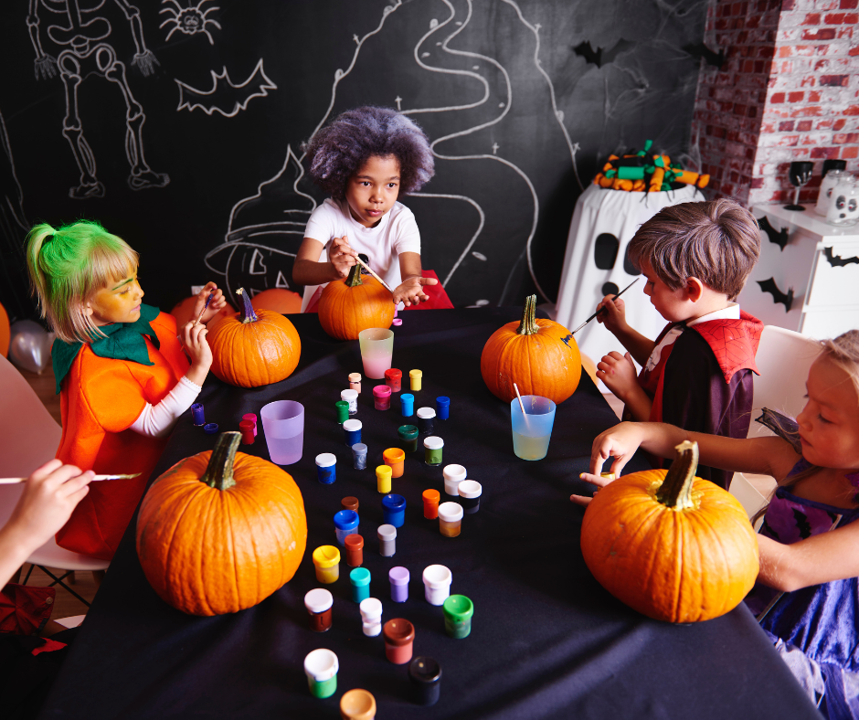 Kids painting pumpkins.