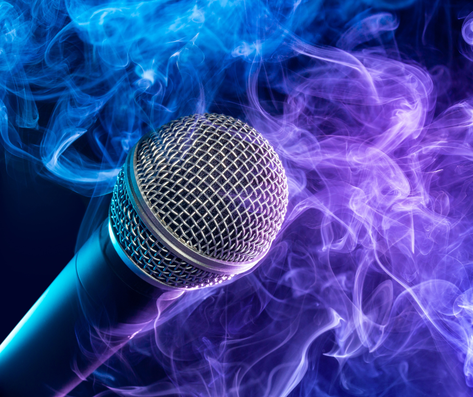 A microphone surrounded by blue and purple smoke.
