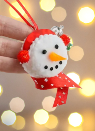 Ai generated image of a snowman ornament over a bokeh light background 