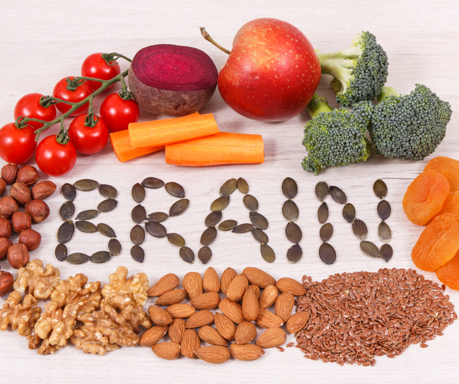 Fruits, Vegetables and nuts in a circle around the word brain spelled out with pumpkin seeds.