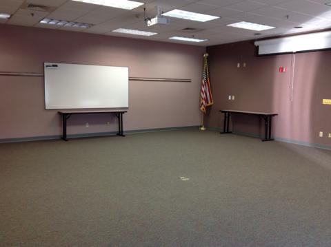 Forest Community Room photo showing an open room setup with a whiteboard at the front of the room