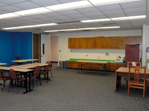 Montvale Community Room with kitchenette, tables, and chairs