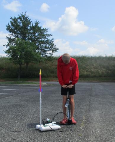 Young man launching a rocket during last year's Rocket launching program at Moneta.