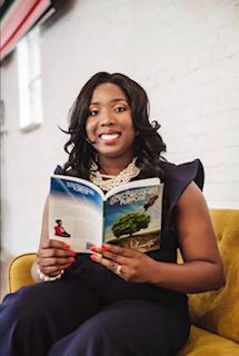 Author Tiffany Amanetu holding her book The three phases of walking in your God-ordained purpose.