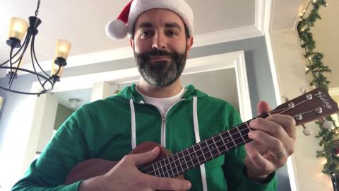 Musician Mr. Jon wearing a Santa hat.