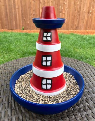 Clay pots stacked and painted to look like a lighthouse