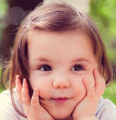 Little girl holding her face in her hands