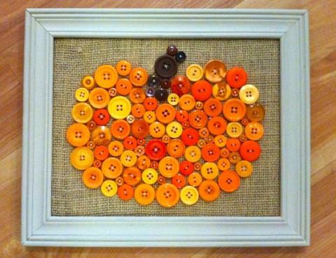 Buttons arranges to look like a pumpkin in a frame.