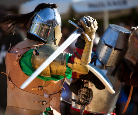 Photo of two medieval knights battling.
