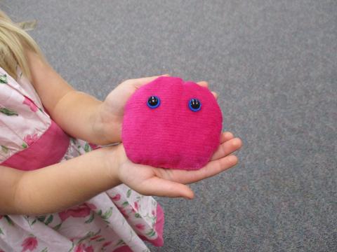Child holding a hand sewn "pet"