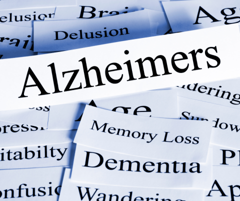 Pieces of paper with Alzheimer's related words on top of each other