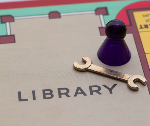 Clue board with the library and a game piece and a wrench.