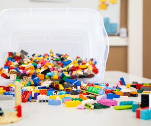 Pile of Legos spilling out of a plastic tub