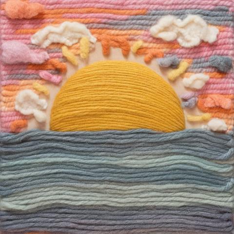 a simple sunrise made out of yarn glued flat to a canvas