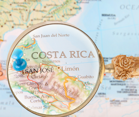 Magnifying glass over a pin in a map of San, Jose Costa Rica