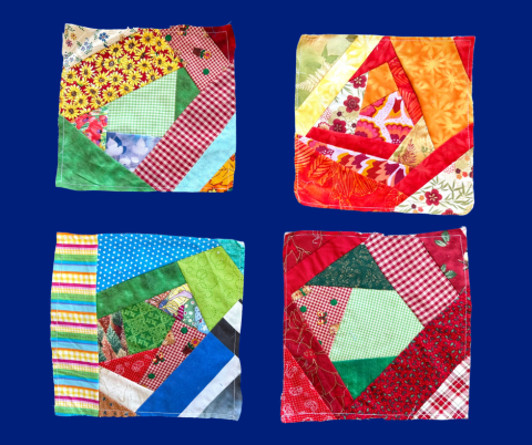 4 quilt squares on a blue background.