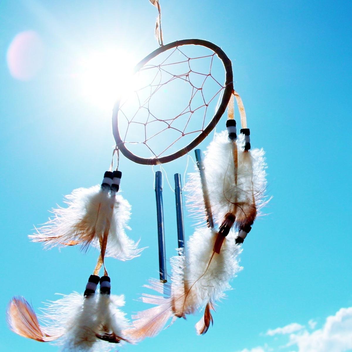 Photo of a dream catcher with a blue sky background.
