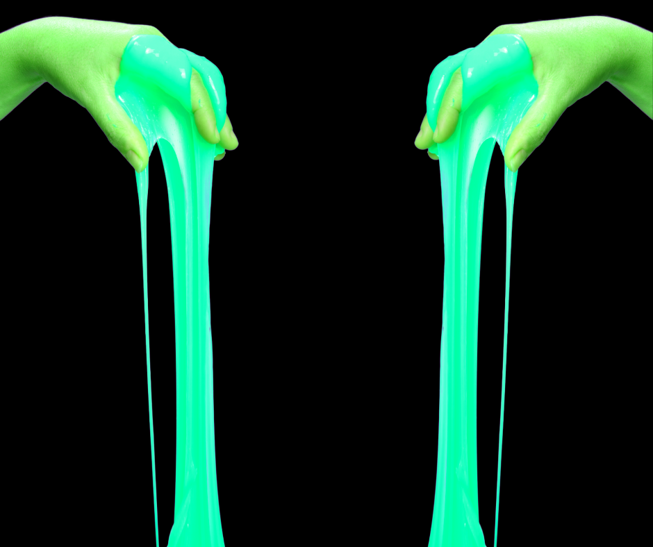 Hands dripping with glow in the dark slime.