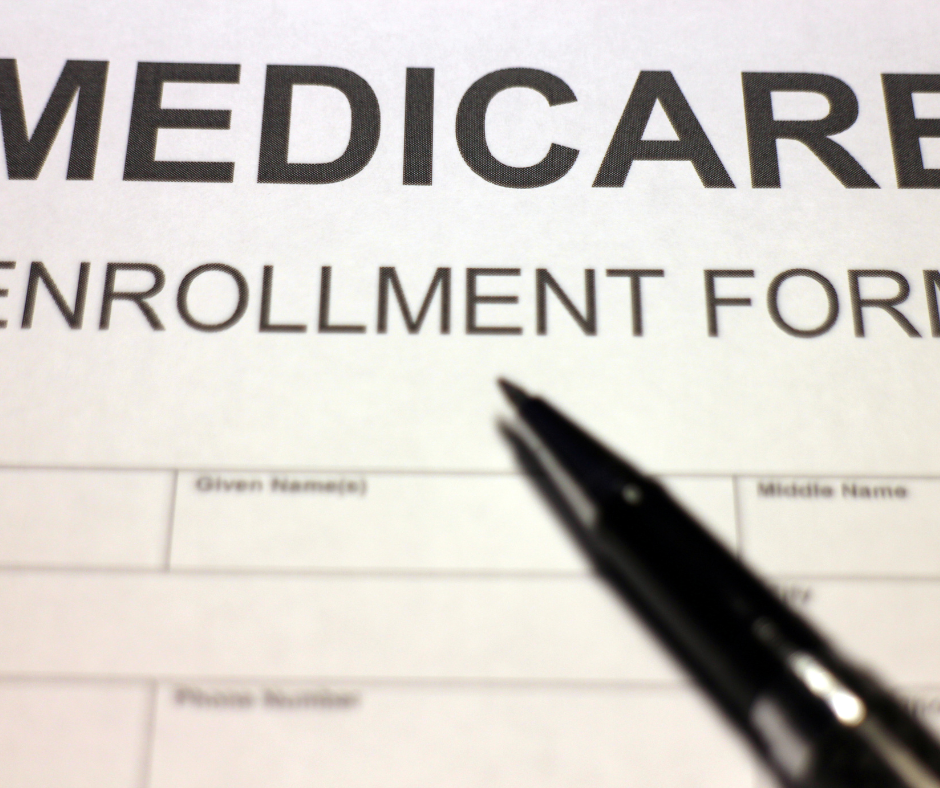 Medicare Enrollment Form and a pen.