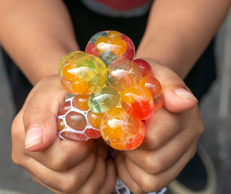 Teen hands squishing a stress ball.