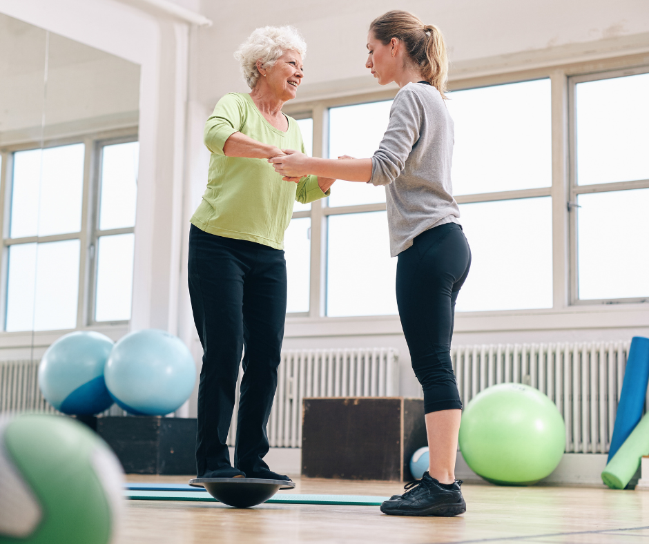 Trainer Helping Senior Woman on Bosu Balance Training Platform